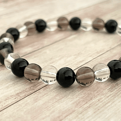 Gros plan sur les perles de tourmaline, quartz fumé et cristal de roche du bracelet
