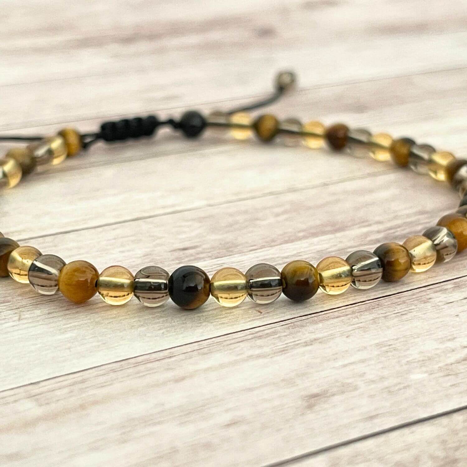 Gros plan des perles 4 mm Citrine, Œil de Tigre et Quartz Fumé.