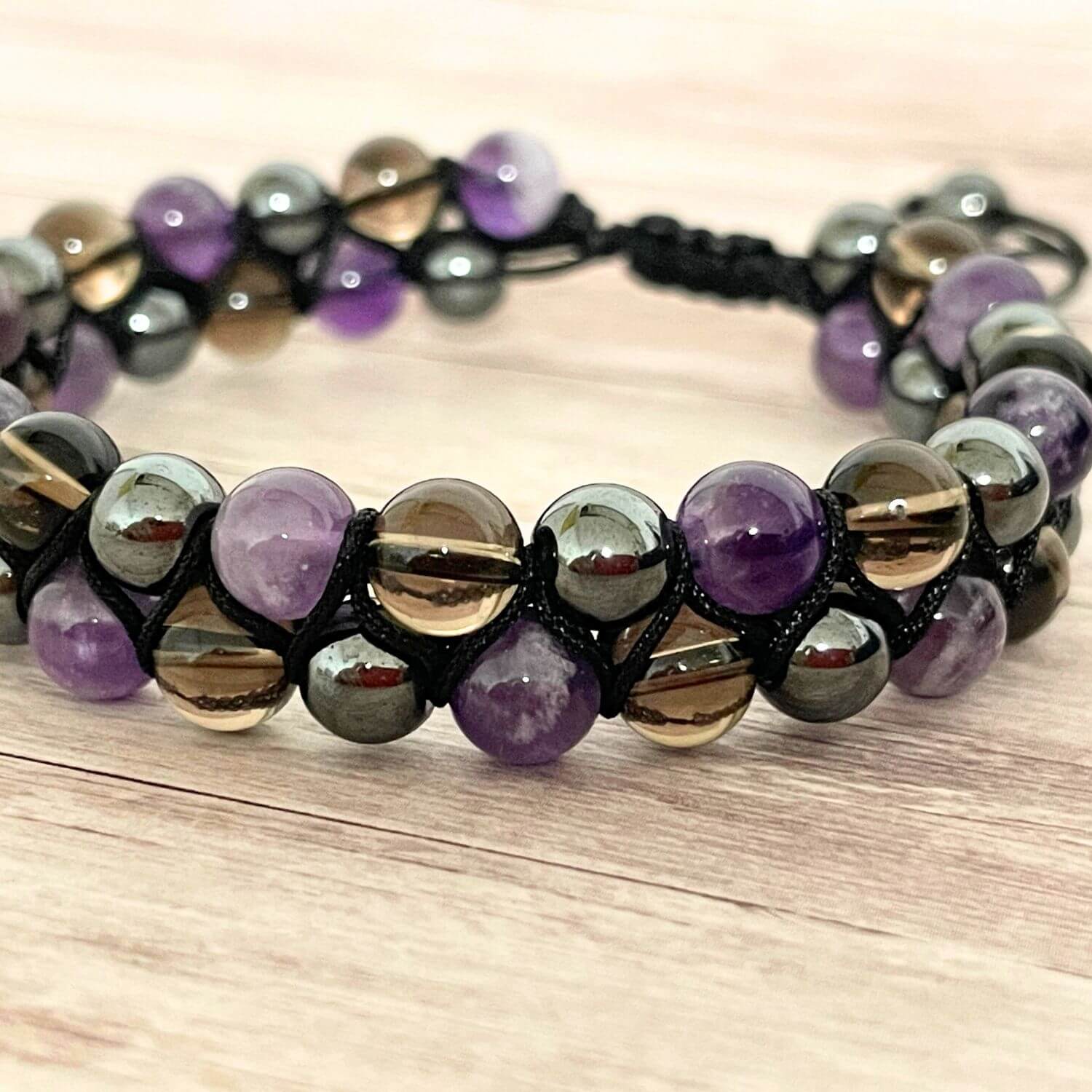 Gros plan des perles 6 mm Améthyste, Hématite et Quartz Fumé, bracelet lithothérapie transition ancrage